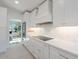 Well-lit kitchen with white cabinetry, stainless steel appliances, and sleek countertops at 4748 E Redfield Rd, Phoenix, AZ 85032