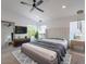 Spacious bedroom featuring neutral tones, a ceiling fan, and large windows, with natural light at 4748 E Redfield Rd, Phoenix, AZ 85032