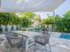 Inviting outdoor dining area with built-in BBQ, ample seating, and view of sparkling pool at 4748 E Redfield Rd, Phoenix, AZ 85032