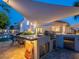 Covered outdoor kitchen boasts a built-in grill, sink, and bar, perfect for outdoor entertaining and al fresco dining at 4748 E Redfield Rd, Phoenix, AZ 85032