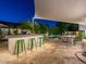 Inviting outdoor space with built-in grill, dining area, bar seating, and a refreshing pool surrounded by lush greenery at 4748 E Redfield Rd, Phoenix, AZ 85032