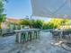 Entertainer's backyard with outdoor kitchen, grill, and bar seating near the pool and dining area at 4748 E Redfield Rd, Phoenix, AZ 85032