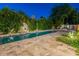 The sparkling pool and lush greenery create a serene backyard oasis perfect for relaxation and entertaining at 4748 E Redfield Rd, Phoenix, AZ 85032