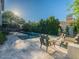 Outdoor space showcasing a refreshing pool, outdoor kitchen, and a cozy seating area with a fire pit at 4748 E Redfield Rd, Phoenix, AZ 85032