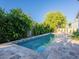 Refreshing pool area with stone tile surround and lush landscaping for ultimate relaxation at 4748 E Redfield Rd, Phoenix, AZ 85032