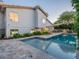 Backyard featuring a sparkling pool, a cozy outdoor kitchen, and mature landscaping around the home at 4748 E Redfield Rd, Phoenix, AZ 85032