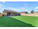 The large backyard has artificial grass and a covered patio at 48069 N Rico Way, Gold Canyon, AZ 85118