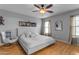A primary bedroom features neutral walls, wood-look floors, and a contemporary ceiling fan at 48069 N Rico Way, Gold Canyon, AZ 85118