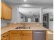 An eat-through kitchen window provides light and an open feeling to the living space at 48069 N Rico Way, Gold Canyon, AZ 85118