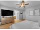 An open primary bedroom provides a TV on the dresser and private bathroom access at 48069 N Rico Way, Gold Canyon, AZ 85118