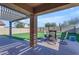 Covered patio with brick pavers and an outdoor dining set, perfect for relaxation at 48069 N Rico Way, Gold Canyon, AZ 85118