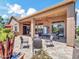 Outdoor patio with seating, a fire pit, and a pool table for entertaining at 4935 W Lariat Ln, Phoenix, AZ 85083