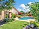 Lush backyard featuring a pool, artificial grass, landscaping, and mature trees, creating a private oasis at 4935 W Lariat Ln, Phoenix, AZ 85083