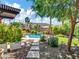 Backyard with mature landscaping with walkway leading to a pebble tec pool and seating area at 4935 W Lariat Ln, Phoenix, AZ 85083