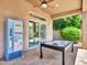 Backyard patio features a pool table, soda machine, and ceiling fan for outdoor enjoyment at 4935 W Lariat Ln, Phoenix, AZ 85083
