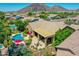 An inviting backyard featuring a sparkling pool, covered patio, and lush landscaping in a desert community at 4935 W Lariat Ln, Phoenix, AZ 85083
