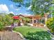 Lush backyard featuring artificial turf, mature trees, a pool, and ample patio space at 4935 W Lariat Ln, Phoenix, AZ 85083