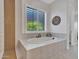 Bright bathroom with a soaking tub and view to exterior at 4935 W Lariat Ln, Phoenix, AZ 85083