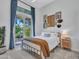 Bright bedroom with a sliding glass door, natural light, gold metal bed, and decorated white wall art at 4935 W Lariat Ln, Phoenix, AZ 85083