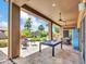 Well appointed covered patio with seating, a pool table and a grill at 4935 W Lariat Ln, Phoenix, AZ 85083