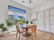 Cozy dining area with a round table, natural light, and views of the beautiful outdoor pool and landscaping at 4935 W Lariat Ln, Phoenix, AZ 85083