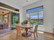 Bright dining area boasts backyard pool views, wood table, and modern chairs at 4935 W Lariat Ln, Phoenix, AZ 85083
