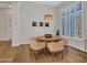 This well-lit dining room features a modern chandelier and wooden floors at 4935 W Lariat Ln, Phoenix, AZ 85083
