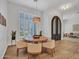 Dining room with a modern light fixture, plantation shutters, and hardwood floors that create an inviting atmosphere at 4935 W Lariat Ln, Phoenix, AZ 85083