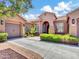 Charming stucco home featuring a tile roof, arched entry, manicured landscaping, and a spacious driveway at 4935 W Lariat Ln, Phoenix, AZ 85083