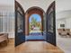 Elegant foyer with hardwood floors and a view through ornate front doors to the outside at 4935 W Lariat Ln, Phoenix, AZ 85083