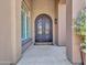 Close-up of a stylish front door with decorative ironwork and transom window at 4935 W Lariat Ln, Phoenix, AZ 85083