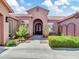 Inviting front exterior featuring a arched doorway, manicured landscaping, and elegant details at 4935 W Lariat Ln, Phoenix, AZ 85083