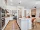 Spacious kitchen boasts white cabinetry, stainless steel appliances, large island, and seamless flow to the living area at 4935 W Lariat Ln, Phoenix, AZ 85083