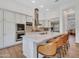 Modern kitchen with white cabinets, stainless steel appliances, and an island with barstool seating at 4935 W Lariat Ln, Phoenix, AZ 85083