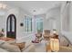 Spacious living room with an arched doorway, plantation shutters, and comfortable seating arrangement at 4935 W Lariat Ln, Phoenix, AZ 85083