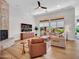 Inviting living room featuring a brick fireplace, comfortable seating, hardwood floors, and lots of natural light at 4935 W Lariat Ln, Phoenix, AZ 85083
