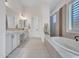 Bright bathroom with double sinks, walk-in shower, and large soaking tub at 4935 W Lariat Ln, Phoenix, AZ 85083