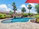 Gorgeous backyard oasis featuring a sparkling blue pool, lush landscaping, and mature palm trees at 4935 W Lariat Ln, Phoenix, AZ 85083