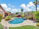 Lush backyard features a sparkling pool, red umbrellas, and mature palm trees for a resort-like setting at 4935 W Lariat Ln, Phoenix, AZ 85083