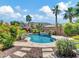 Stunning backyard featuring a pebble tec pool, mature landscaping, and a serene mountain view at 4935 W Lariat Ln, Phoenix, AZ 85083