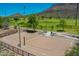 Scenic view of a sand volleyball court surrounded by lush greenery and mountain views at 4935 W Lariat Ln, Phoenix, AZ 85083