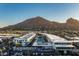 Stunning aerial view of the complex, showcasing the pool, palm trees, parking, and mountain backdrop at 5455 E Lincoln Dr # 3006, Paradise Valley, AZ 85253