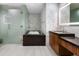 Luxurious bathroom with soaking tub, glass shower, modern vanity, and elegant marble accents at 5455 E Lincoln Dr # 3006, Paradise Valley, AZ 85253