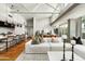 Open-concept living area with bar seating, hardwood floors, comfortable seating, and modern design elements at 5455 E Lincoln Dr # 3006, Paradise Valley, AZ 85253