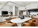 Modern open-concept living area featuring hardwood floors, white seating, contemporary dining set, and stylish decor at 5455 E Lincoln Dr # 3006, Paradise Valley, AZ 85253