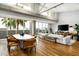 Open-concept living room boasts natural light, hardwood floors, comfortable seating, and floor to ceiling windows at 5455 E Lincoln Dr # 3006, Paradise Valley, AZ 85253