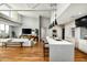 Bright, open-concept living area showcasing modern kitchen, bar seating, hardwood floors, and contemporary decor at 5455 E Lincoln Dr # 3006, Paradise Valley, AZ 85253