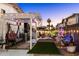 Picturesque backyard featuring a pergola, seating area, decorative planters, and ambient lighting at 5534 E Player Pl, Mesa, AZ 85215