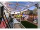 Backyard with a covered patio, swing, artificial turf, and ambient string lighting at 5534 E Player Pl, Mesa, AZ 85215