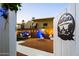 Inviting gated backyard featuring festive string lights, manicured landscaping, and desert charm at 5534 E Player Pl, Mesa, AZ 85215